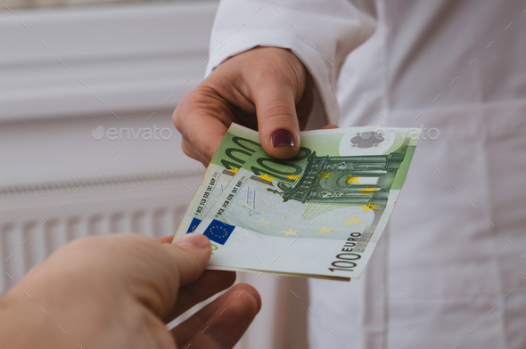A female doctor getting paid by the euros. - Stock Photo - Images