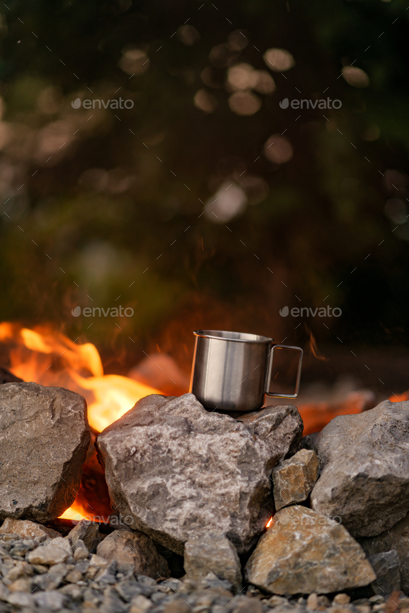 Close-up of a cup of the stone, next to the fireplace - Stock Photo - Images