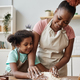 Happy black mother and daughter baking together in cozy home kitchen - PhotoDune Item for Sale