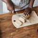 Of black woman baking homemade pastry on dark wood kitchen counter - PhotoDune Item for Sale