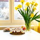 Easter cake, eggs and bunch of narcissus on a table - PhotoDune Item for Sale
