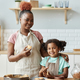 Mother and daughter enjoying baking together in kitchen - PhotoDune Item for Sale