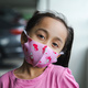 Child, little girl in a pink protective face mask, portrait, closeup. - PhotoDune Item for Sale