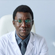 Young black doctor looking at camera sitting at desk - PhotoDune Item for Sale