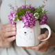  Female Hands holding coffee cup with Colorful bouquet of wild flowers at home - PhotoDune Item for Sale