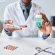 Close up African American doctor holding bottle of pills to camera pointing - PhotoDune Item for Sale