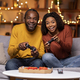 Cool african american couple playing video games at home - PhotoDune Item for Sale