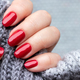 Female hand with beautiful manicure - red glittered nails. Selective focus. Closeup view - PhotoDune Item for Sale
