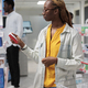 African american woman choosing medications in pharmacy store - PhotoDune Item for Sale