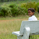 Portrait of boy seen sitting on bench in nature - PhotoDune Item for Sale