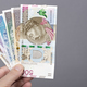 Polish Zloty in the hand on a gray background - PhotoDune Item for Sale