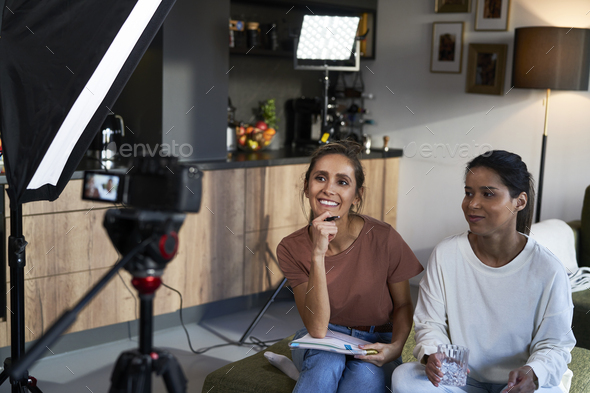 Two female vloggers recording a movie - Stock Photo - Images
