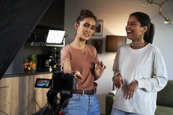 Two female women having fun while recording a video vlog - Stock Photo - Images