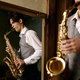 Young man playing saxophone in reflection of mirror at home - PhotoDune Item for Sale