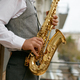 Saxophonist playing music outdoors, closeup saxophone in musician hand - PhotoDune Item for Sale