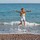 Cute child girl jumping on the beach - PhotoDune Item for Sale