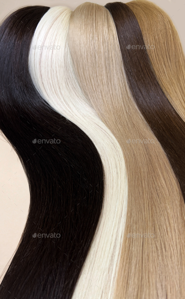 Strands of natural hair of different colors for extensions. Hair color palette