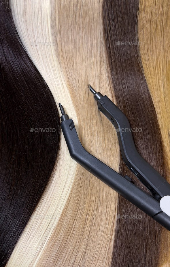 Strands of natural hair in different colors for extensions with tools. Hair color palette.