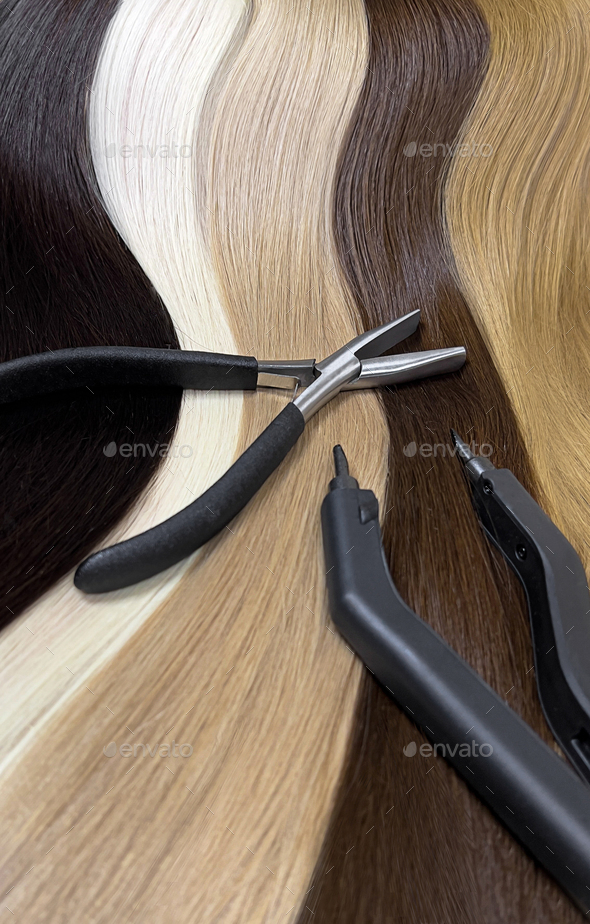 Strands of natural hair in different colors for extensions with tools. Hair color palette.