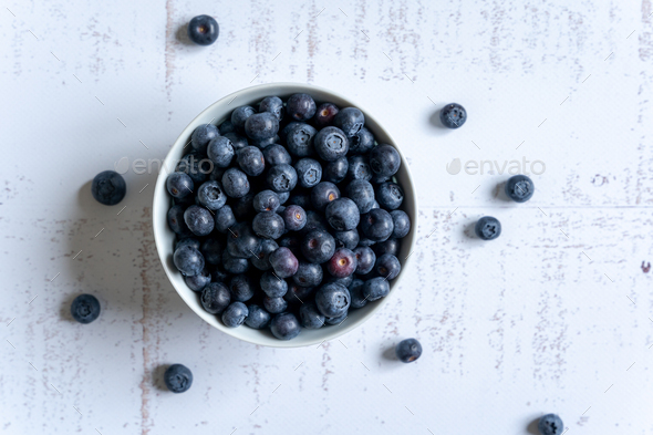 Top down view of a bowl of fresh blueberries on white background - Stock Photo - Images