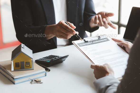Rental company employee is calculating the cost for the customer to agree to sign a rental contract