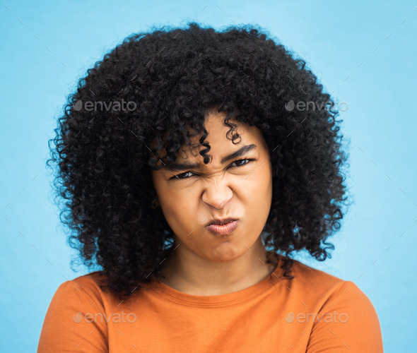Black woman, portrait or angry facial expression on isolated blue background in mental health burno