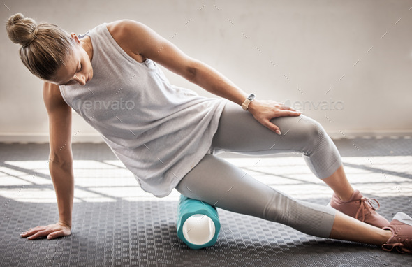 Fitness, physio massage and woman with roller on floor for leg tension and support in yoga workout - Stock Photo - Images