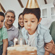 Kids, birthday cake and kid blowing candles at a house at a party with food and celebration. Childr - PhotoDune Item for Sale