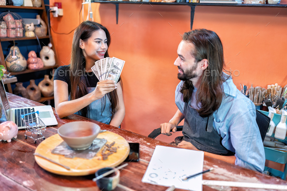 Couple pottery owner online running a successful small business together got good cash flow money
