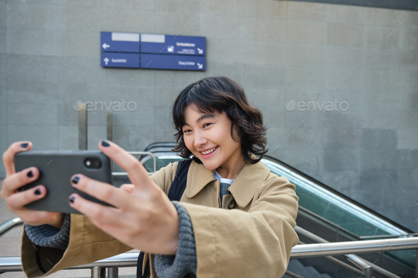 Happy University Student, Korean Girl Takes Selfie with Her Papers and  Digital Tablet, Holds Smartphone and Poses Near Stock Image - Image of  outdoor, freelance: 268252129