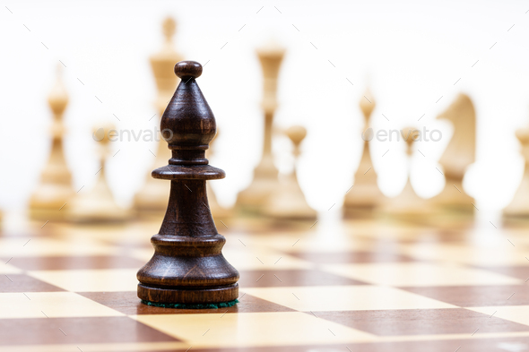 bishop against white chess figures in background - Stock Photo - Images