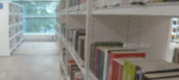 Blurred view of shelves with books in library  - Stock Photo - Images