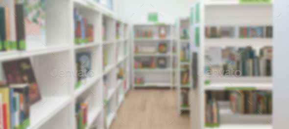 Blurred view of shelves with books in library  - Stock Photo - Images