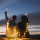 Couple enjoy valentine&#39;s day seated with sparkle against the sunset - PhotoDune Item for Sale