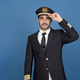 Airline pilot wearing uniform greeting with his hat - PhotoDune Item for Sale