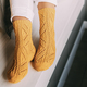 Close up of female legs in yellow knitted winter socks, white tr - PhotoDune Item for Sale