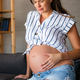 Pregnant woman having abdominal and back aches in the last trimester of pregnancy at home - PhotoDune Item for Sale