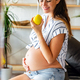 Pregnancy, healthy food and people concept Happy pregnant woman eating apple. healthy food. - PhotoDune Item for Sale