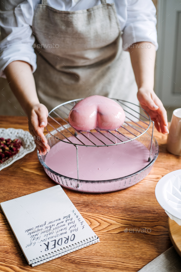 Perfect custom pink heart shape made cake in kitchen Bakery. Online Cake Store. custom cake order