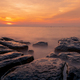 Rocks on stone beach at sunset. Beautiful beach sunset sky. Twilight sea and sky. Tropical sea - PhotoDune Item for Sale
