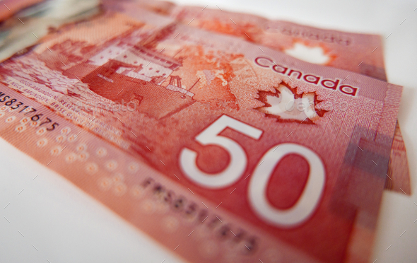 Closeup shot of Canadian money on a white surface