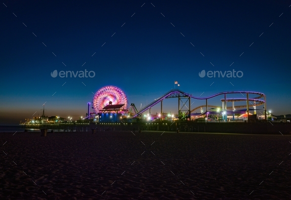 Illuminated roller coaster in Santa Monica, CA at night - Stock Photo - Images