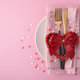 Valentine&#39;s Day background. A set of golden cutlery and pink napkin on plate with hearts confetti - PhotoDune Item for Sale
