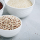 Quinoa. Red white brown quinoa seeds in bowl. Mixed raw quinoa seeds on gray stone background. - PhotoDune Item for Sale