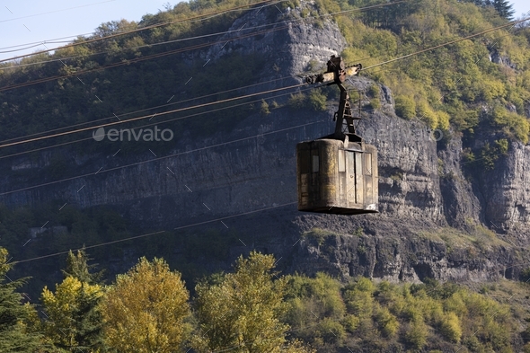 A disused cable car hangs over the river in Chiatura, Georgia - Mining Town