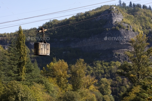 A rusty cable car hangs over the river in Chiatura, Georgia - Mining Town