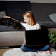 Portrait girl using laptop, sitting on the floor carpet with her dog in living room at home - PhotoDune Item for Sale
