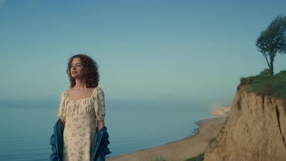 Peaceful Woman Standing Beach Alone with Clothed Eyes alt