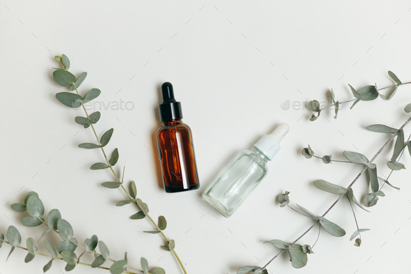 Two cosmetics glass dropper bottles with pipette for essential oil or serum on white - Stock Photo - Images