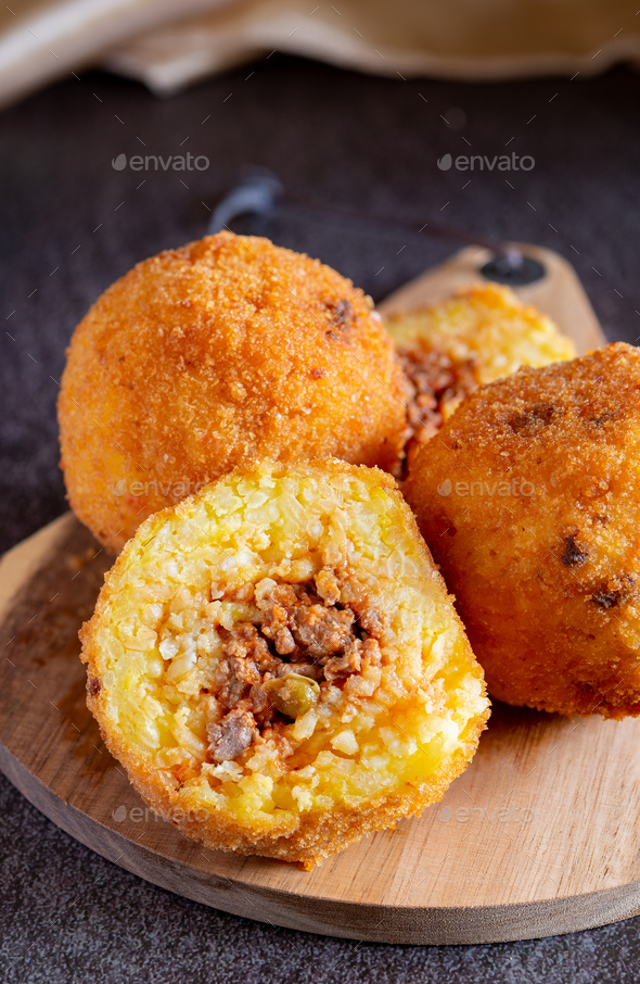 Fried stuffed Sicilian arancini with breadcrumbs crust - Stock Photo - Images